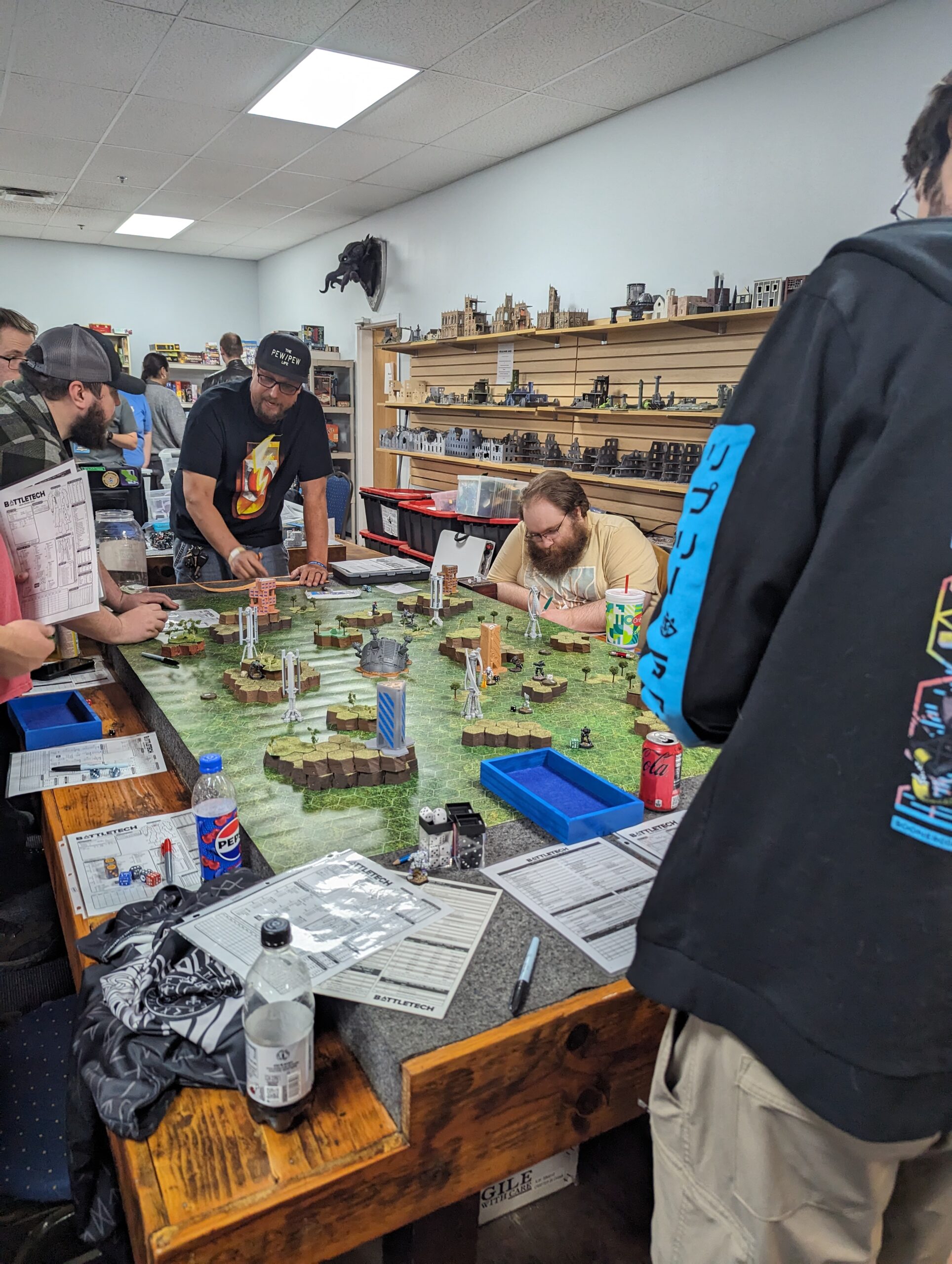 non-profit-10 A group of people play Battletech around a table.